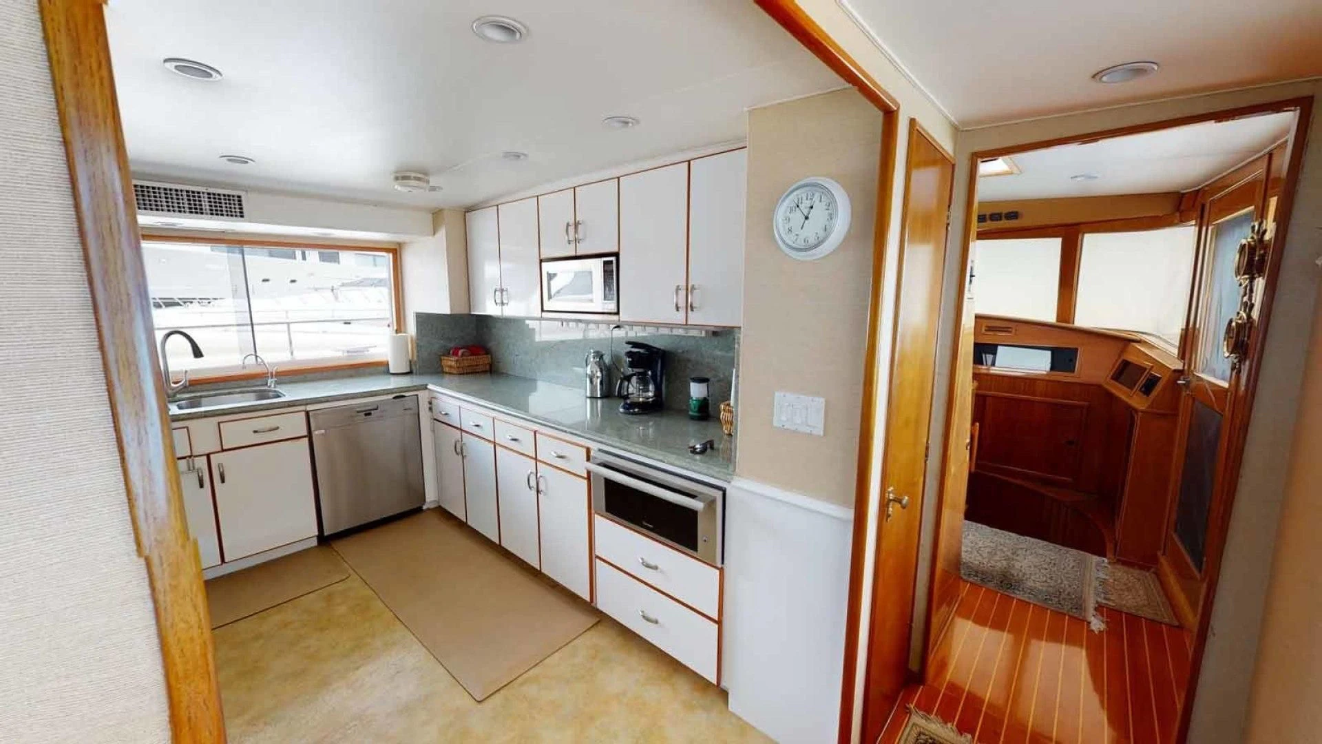 a kitchen with white cabinets aboard LORELEI Yacht for Sale