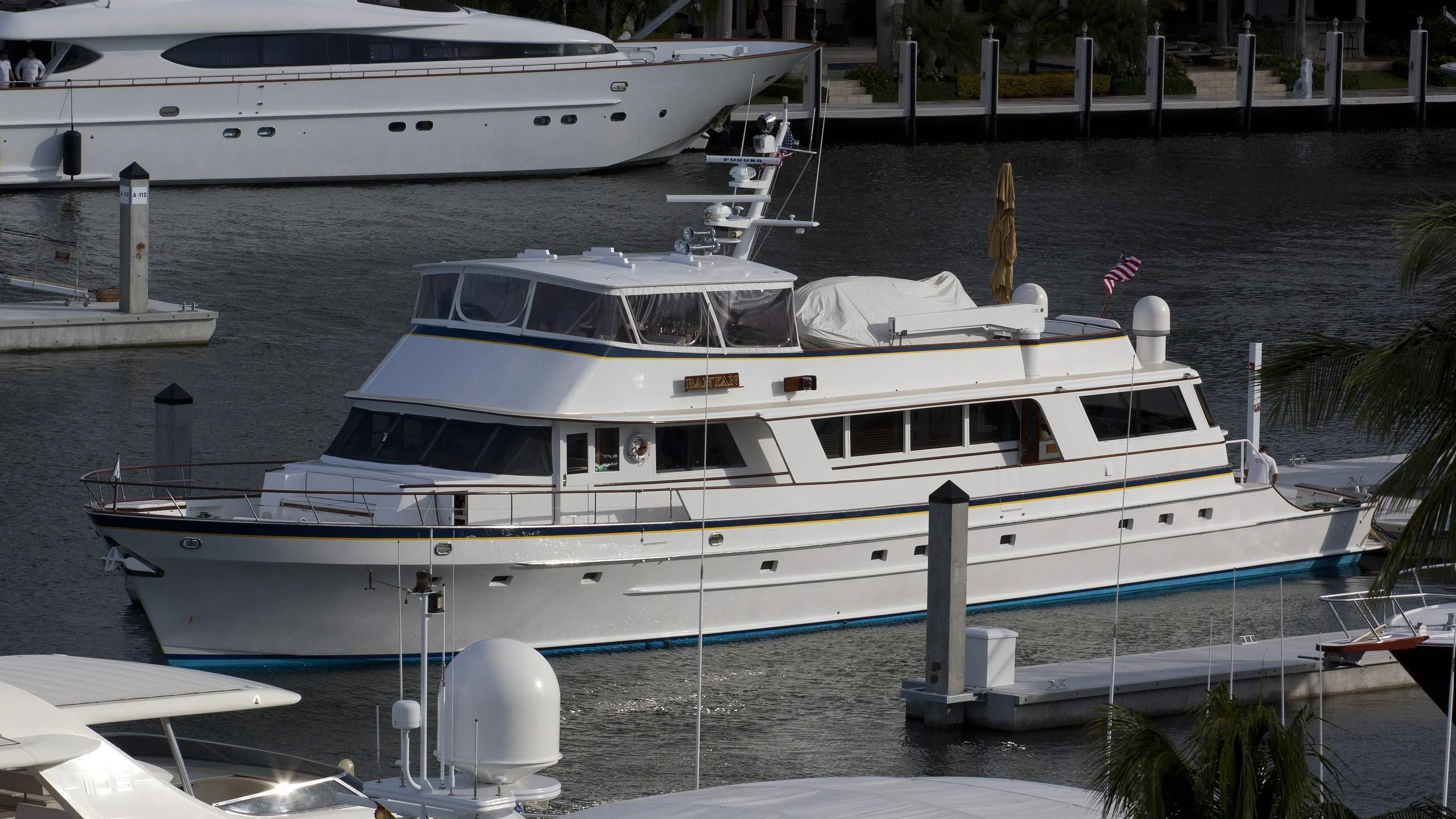 a white yacht docked at a pier aboard LORELEI Yacht for Sale