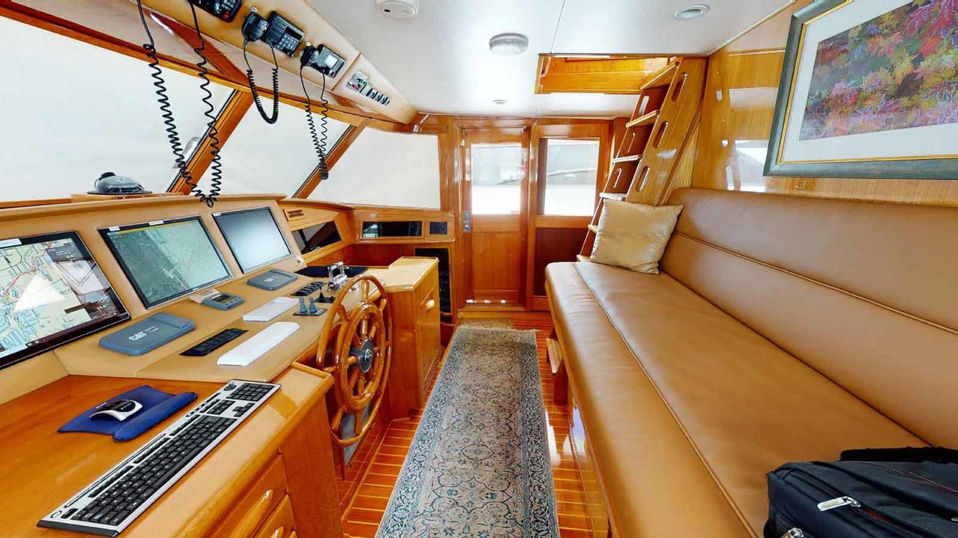 a room with a couch and a desk with computers on it aboard LORELEI Yacht for Sale