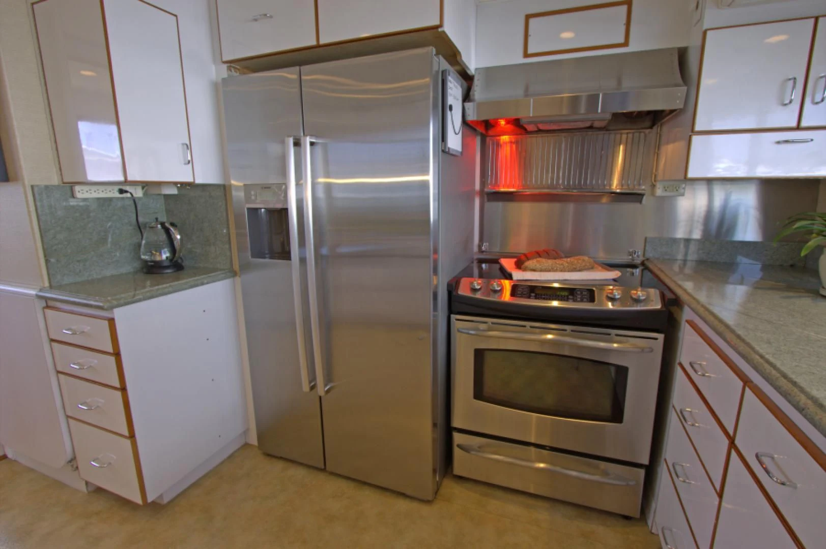 a kitchen with white cabinets aboard LORELEI Yacht for Sale