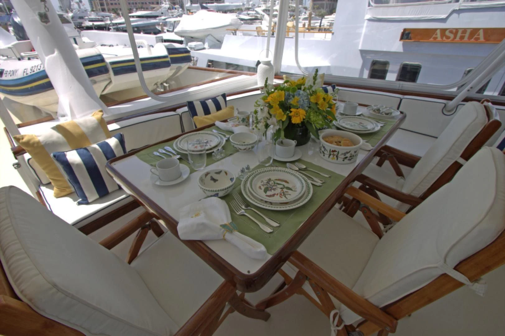 a table with plates and cups on it aboard LORELEI Yacht for Sale