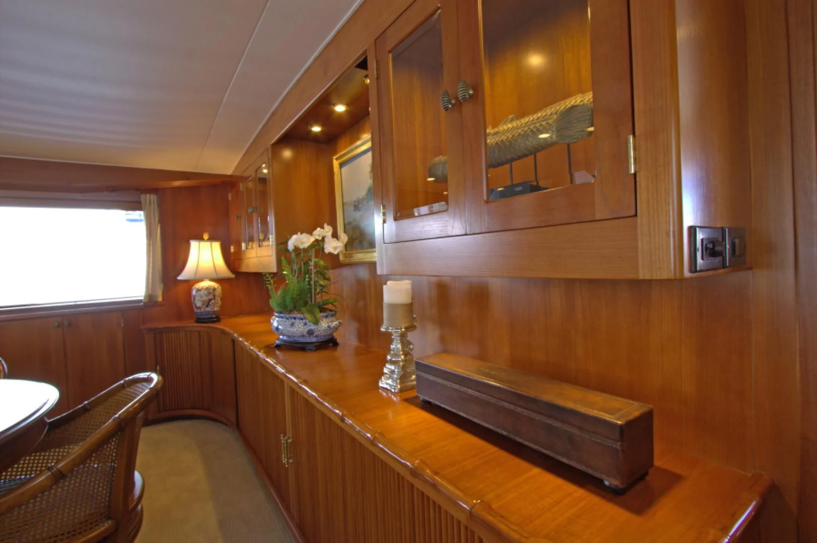 a wooden cabinet with a mirror above it aboard LORELEI Yacht for Sale