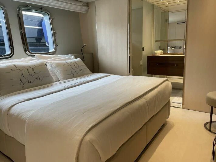 a bed with white sheets aboard PIACERE III Yacht for Sale