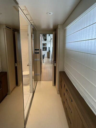 a hallway with a toilet and a door aboard PIACERE III Yacht for Sale