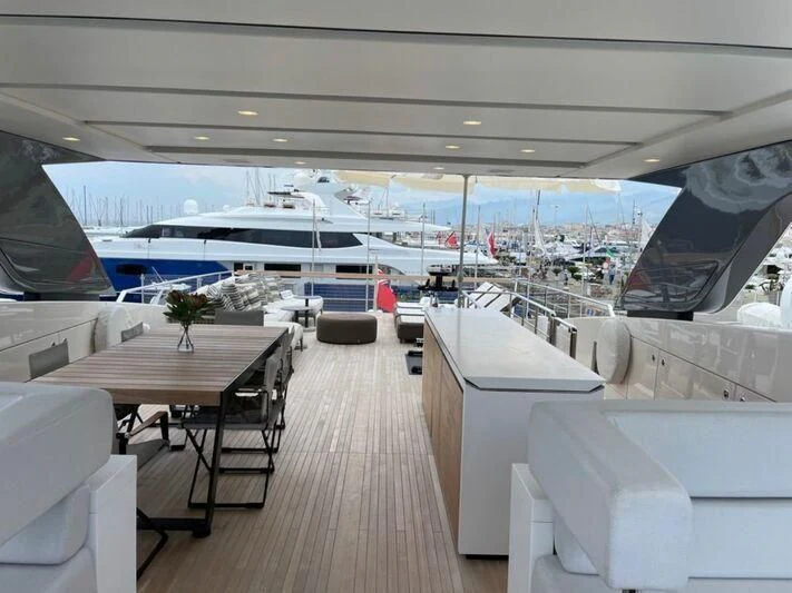 a room with a table and chairs aboard PIACERE III Yacht for Sale