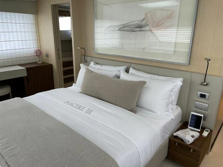 a bed with white sheets aboard PIACERE III Yacht for Sale