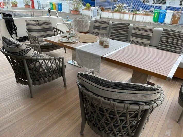 a table with chairs and a table aboard PIACERE III Yacht for Sale