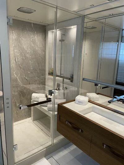 a bathroom with a glass shower aboard PIACERE III Yacht for Sale