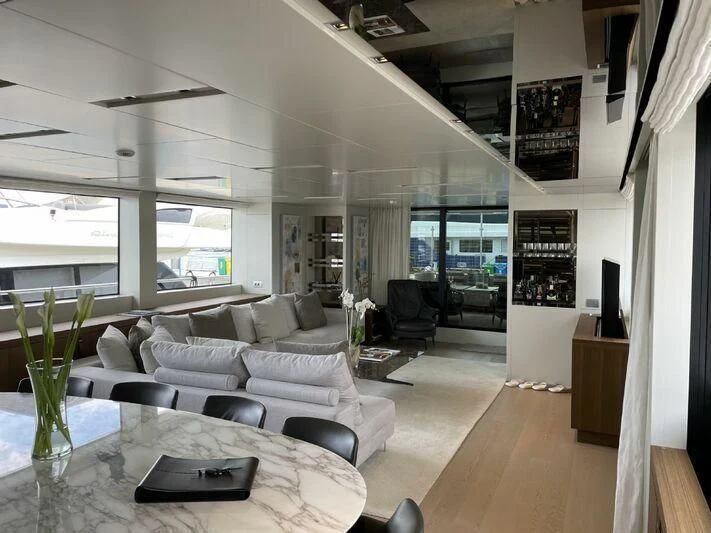 a living room with a large window aboard PIACERE III Yacht for Sale