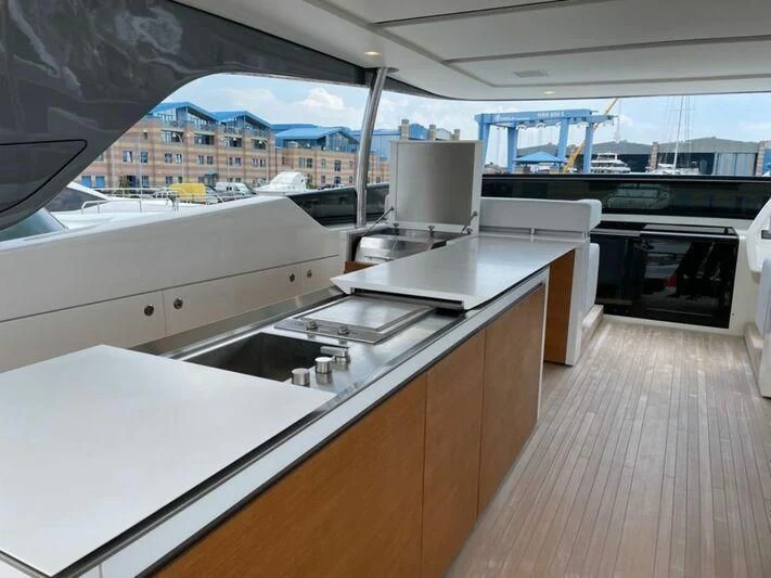 a kitchen with a large window aboard PIACERE III Yacht for Sale
