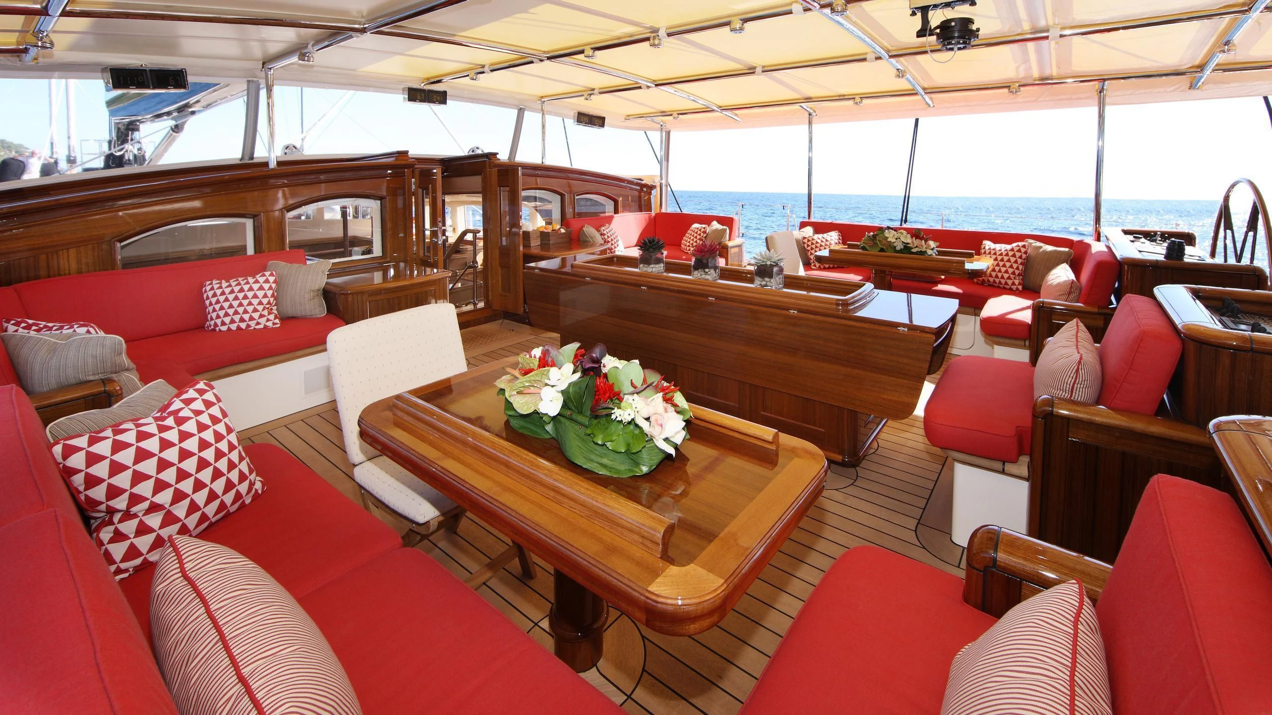 a room with red seats and tables aboard MARIE Yacht for Sale