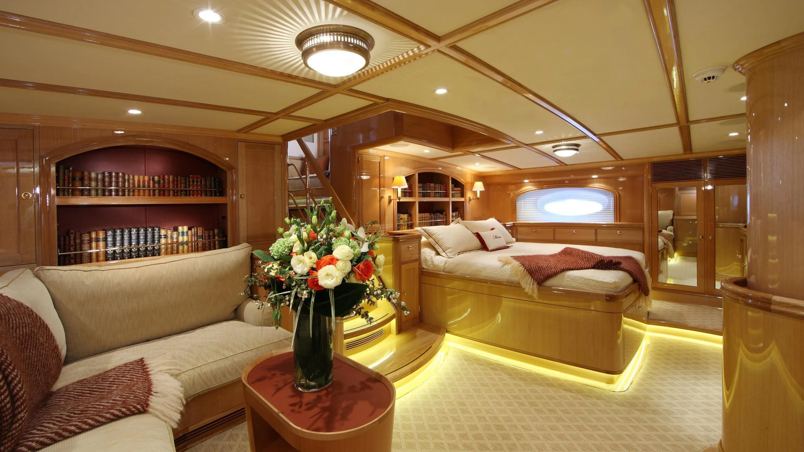 a living room with a couch and a vase of flowers aboard MARIE Yacht for Sale