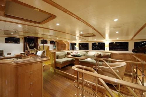 a room with a wood floor and a wood floor with chairs and a counter with a bar and aboard MARIE Yacht for Sale