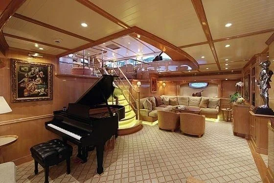 a large living room with a grand piano and a piano aboard MARIE Yacht for Sale