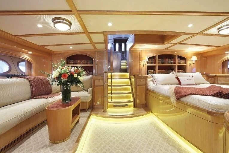 a room with a bed and a chair aboard MARIE Yacht for Sale