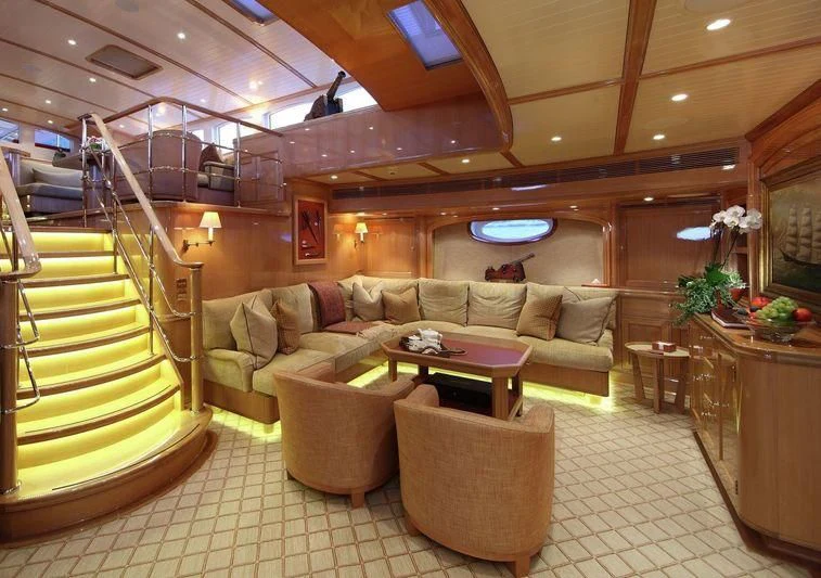 a living room with a couch and a staircase aboard MARIE Yacht for Sale