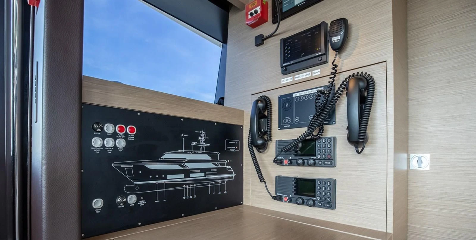 a computer with a screen and a phone on the side aboard OCEAN Z Yacht for Sale
