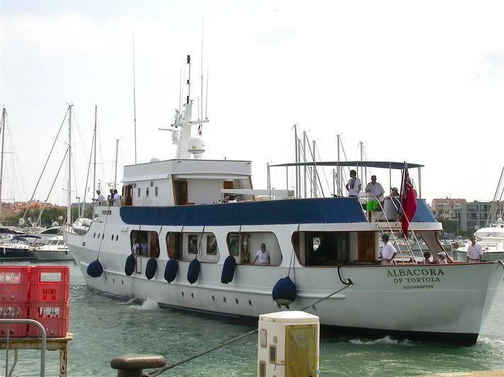 a boat docked at a pier aboard ALBACORA Yacht for Sale