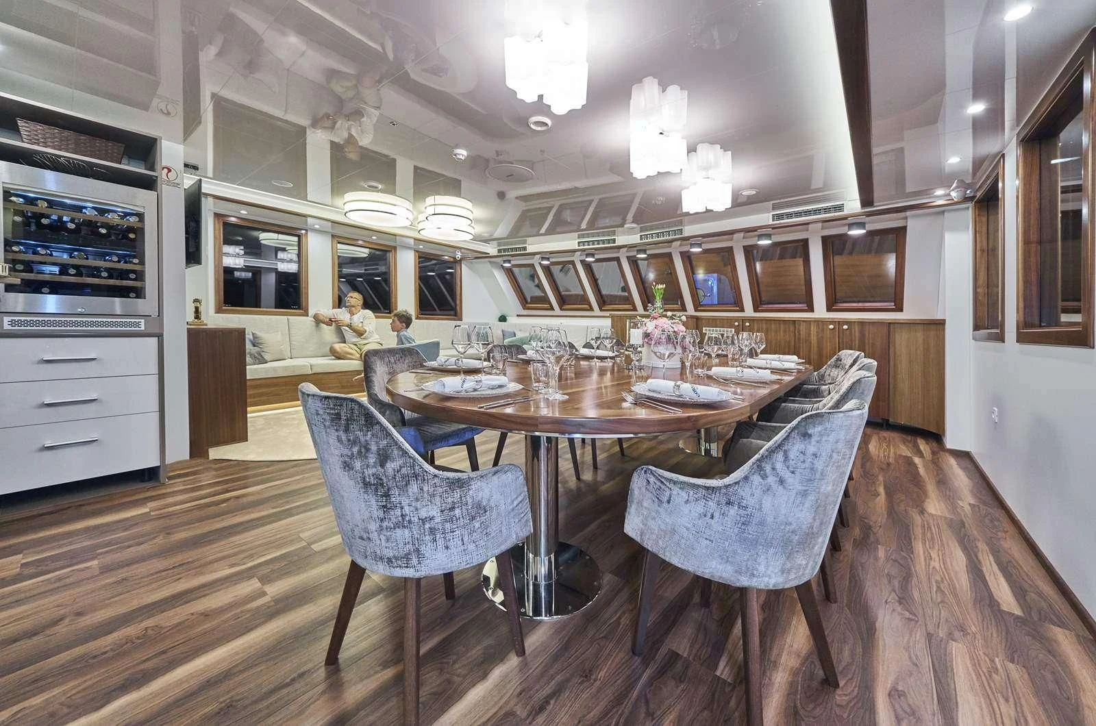 a kitchen with a dining table and chairs aboard CORSARIO Yacht for Charter