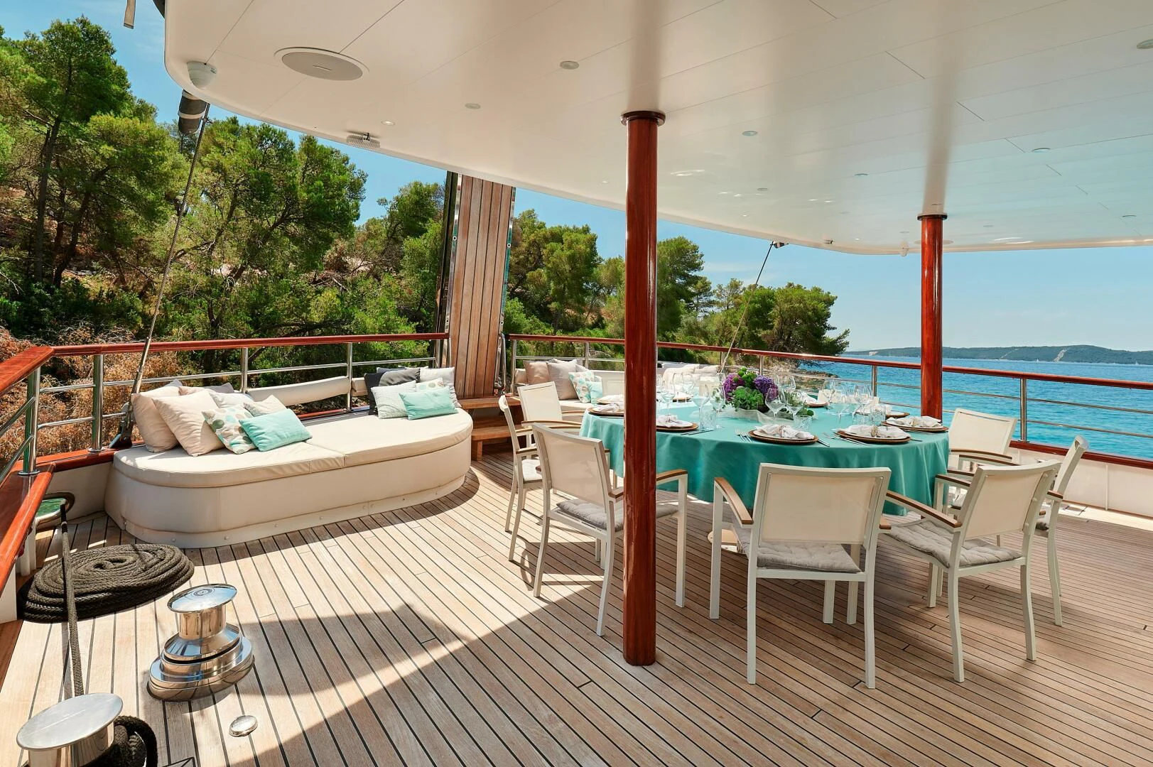 a pool with a deck and a deck and a large pool aboard CORSARIO Yacht for Charter