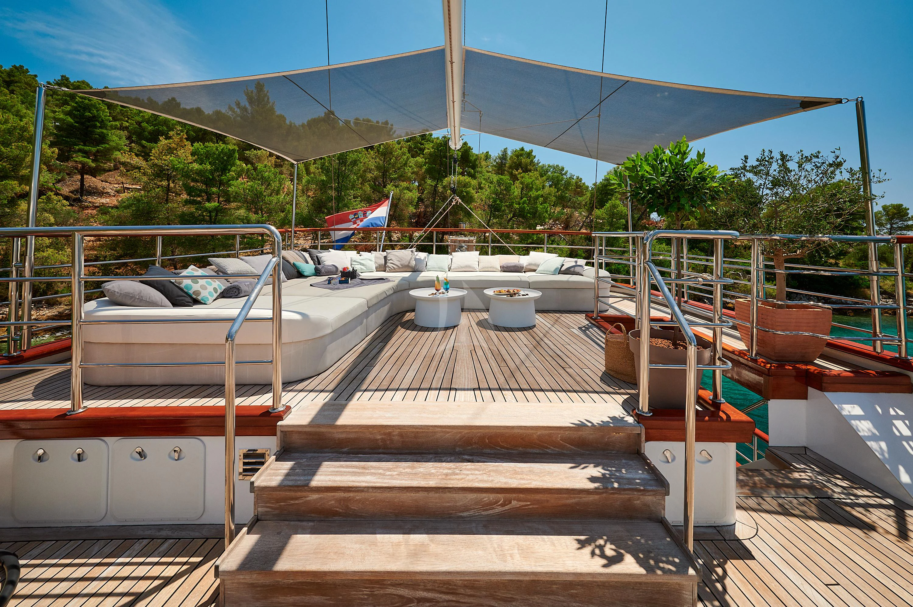 a deck with a deck and chairs aboard CORSARIO Yacht for Charter