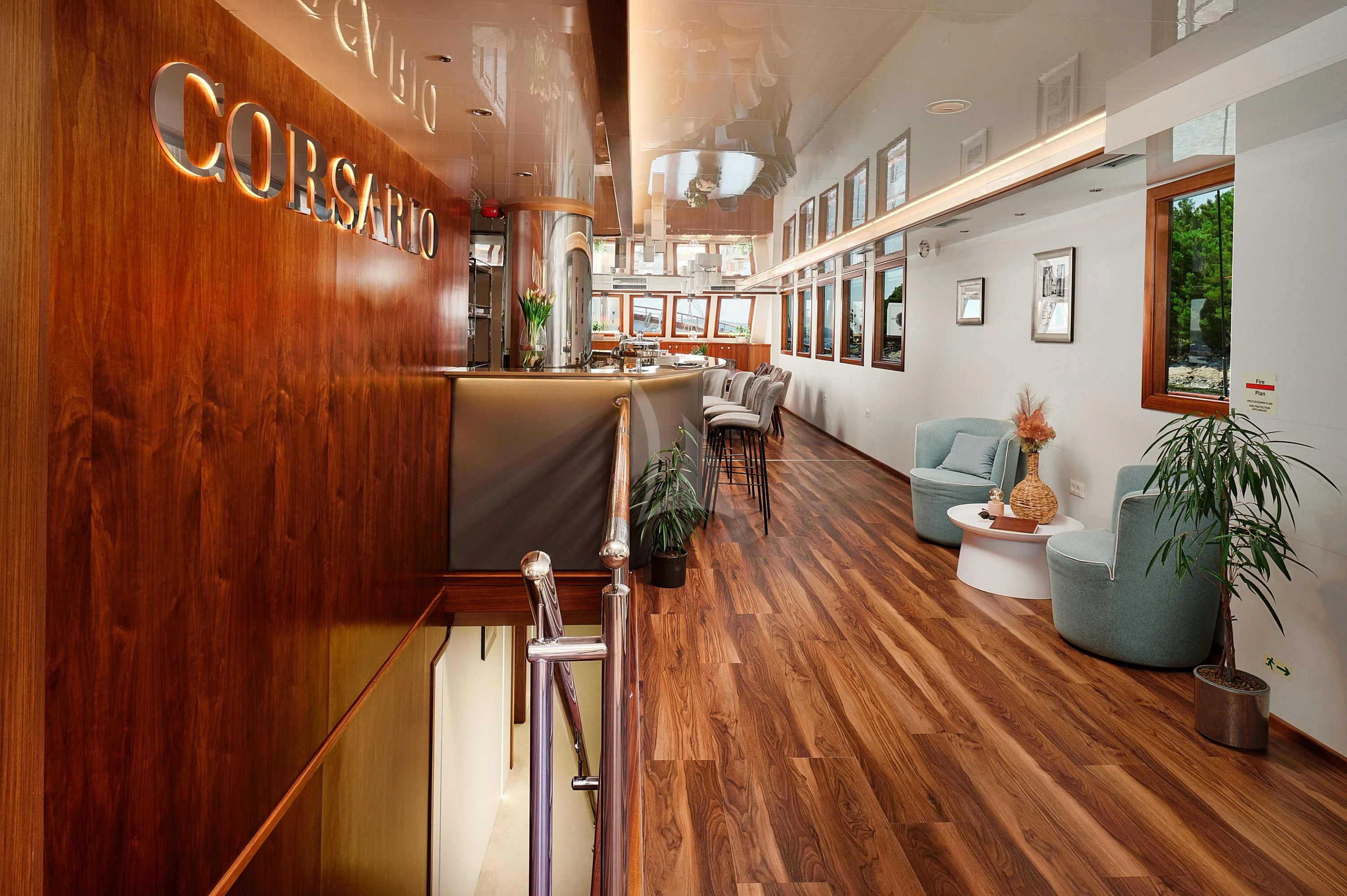 a room with a table chairs and plants aboard CORSARIO Yacht for Charter