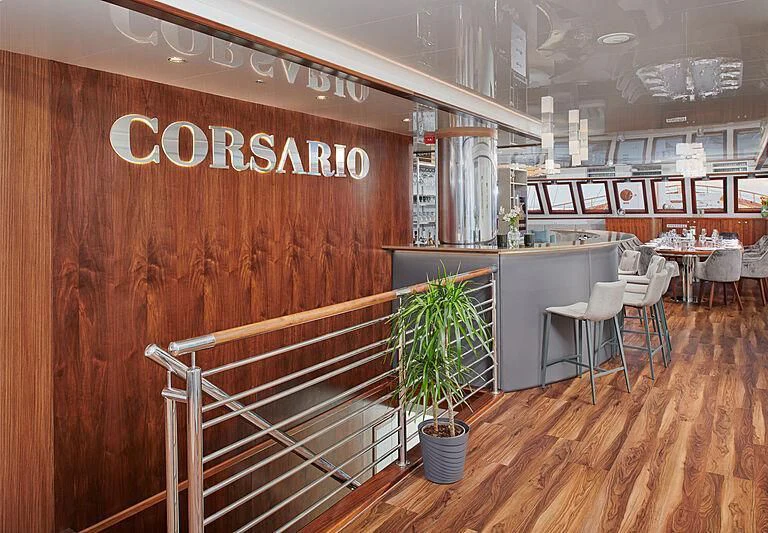 a restaurant with tables and chairs aboard CORSARIO Yacht for Charter