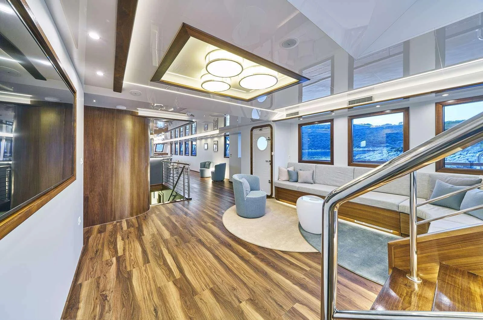 a room with a wood floor and a large window aboard CORSARIO Yacht for Charter