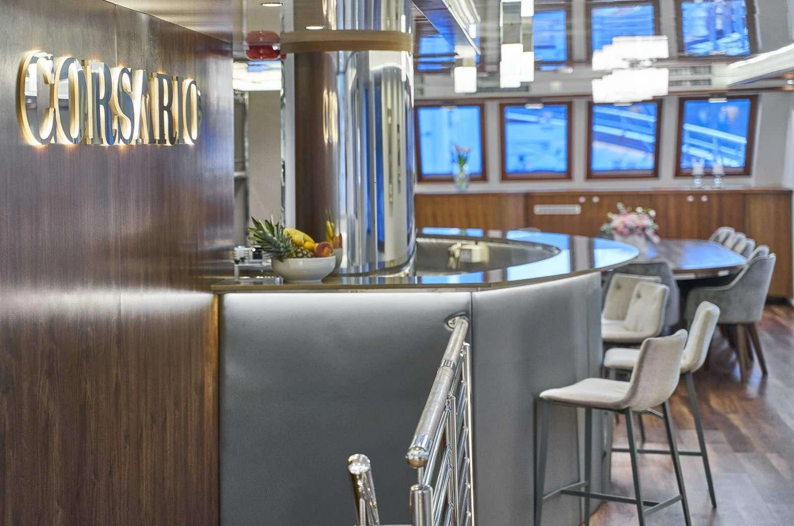 a restaurant with a bar and chairs aboard CORSARIO Yacht for Charter