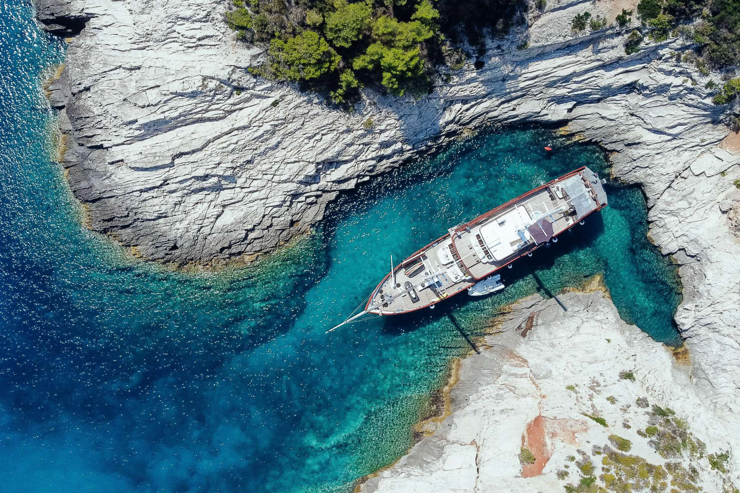 a toy ship on a body of water aboard CORSARIO Yacht for Charter