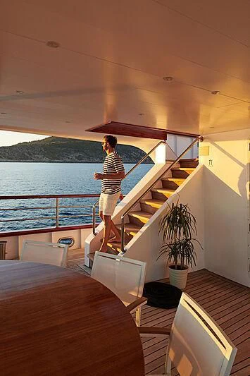a person standing on a balcony aboard CORSARIO Yacht for Charter
