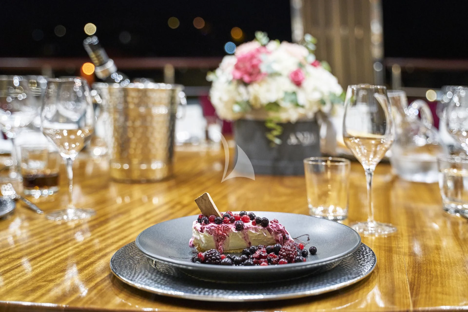 a plate of dessert and glasses aboard CORSARIO Yacht for Charter