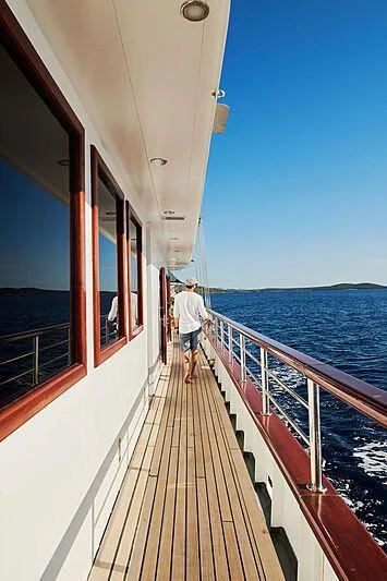 a person walking on a boardwalk aboard CORSARIO Yacht for Charter