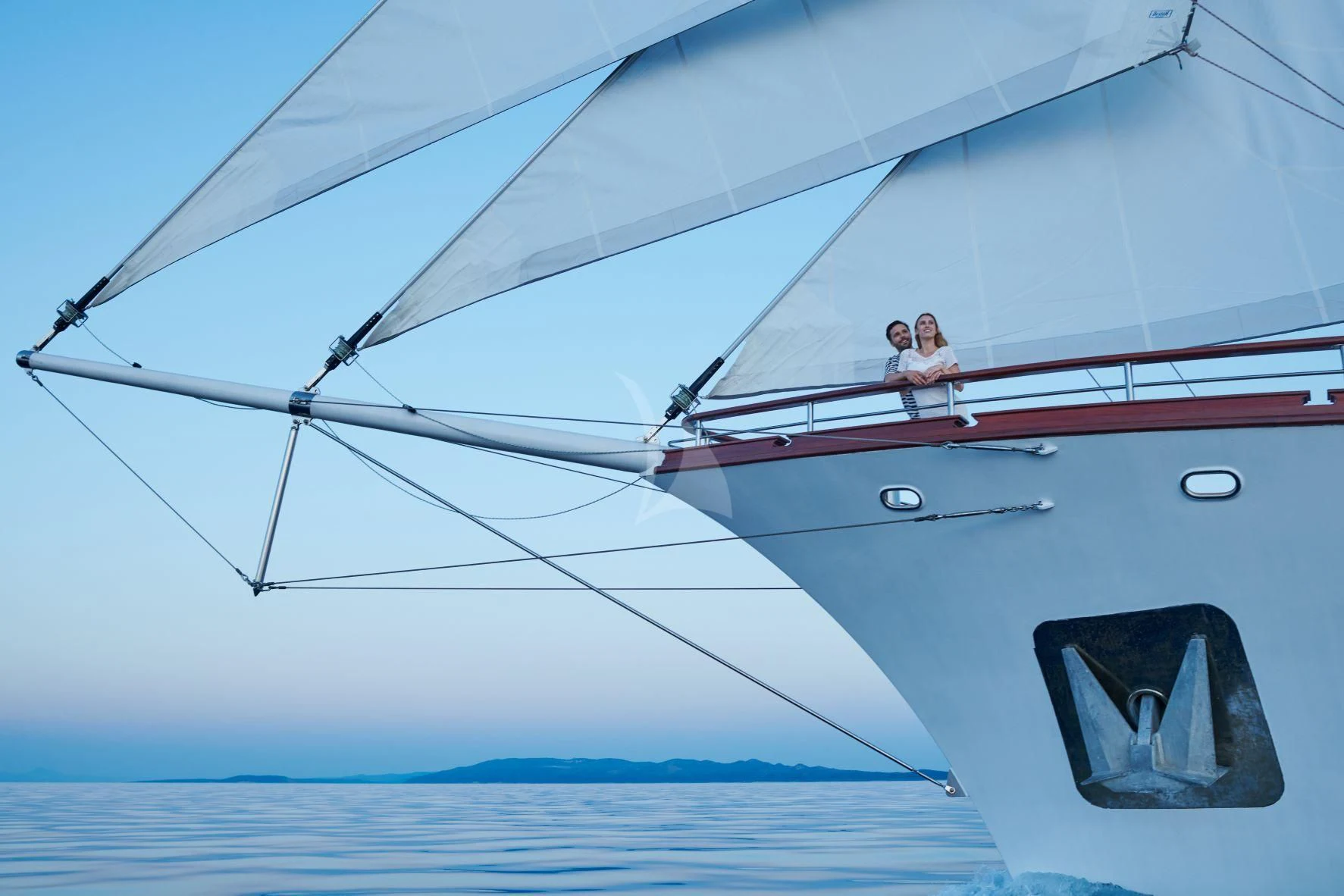 two people sitting on a sailboat aboard CORSARIO Yacht for Charter