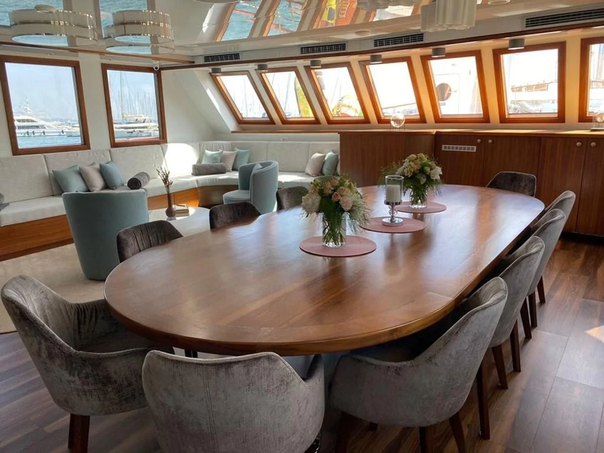 a large room with a table and chairs aboard CORSARIO Yacht for Charter