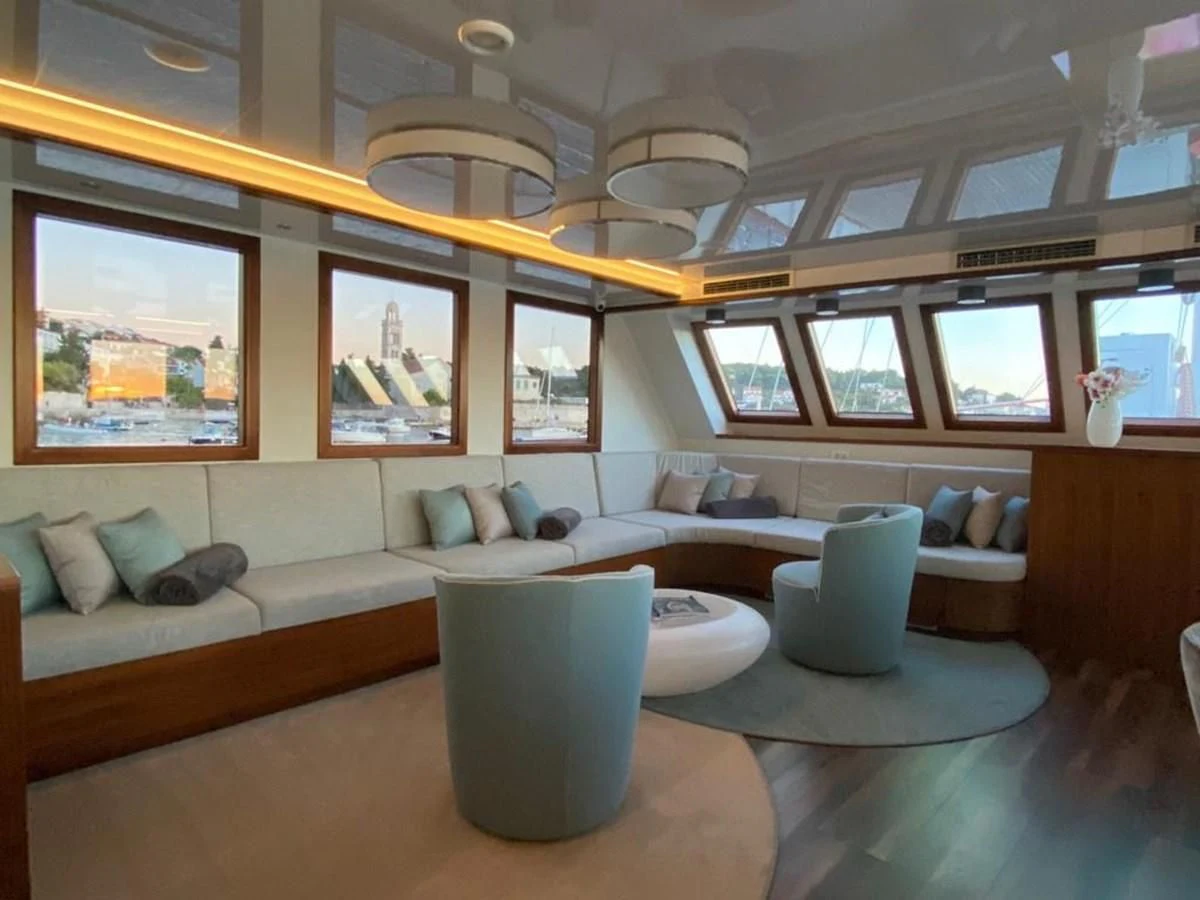 a room with a couch and a table aboard CORSARIO Yacht for Charter