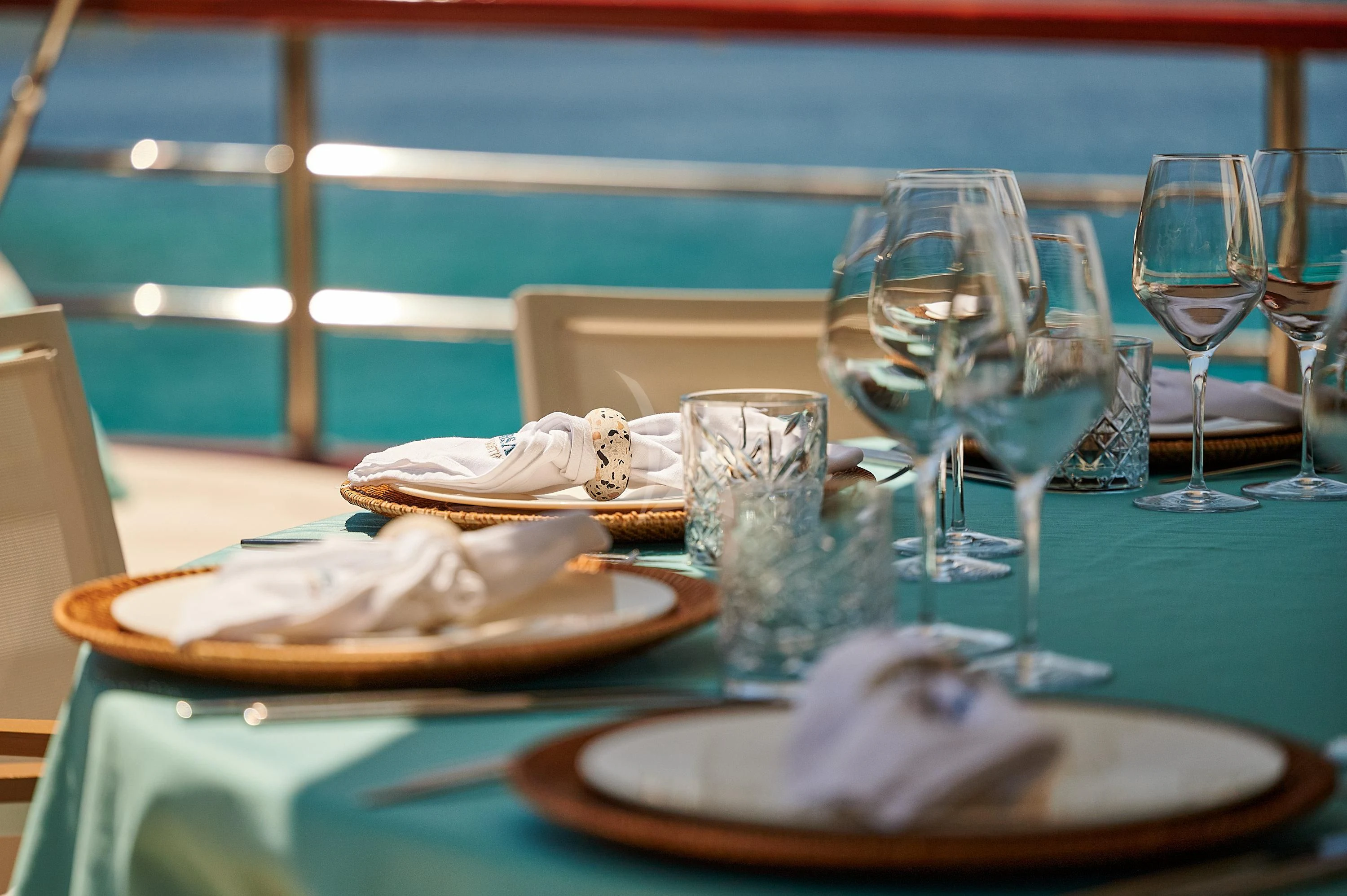 a table with wine glasses and food on it aboard CORSARIO Yacht for Charter