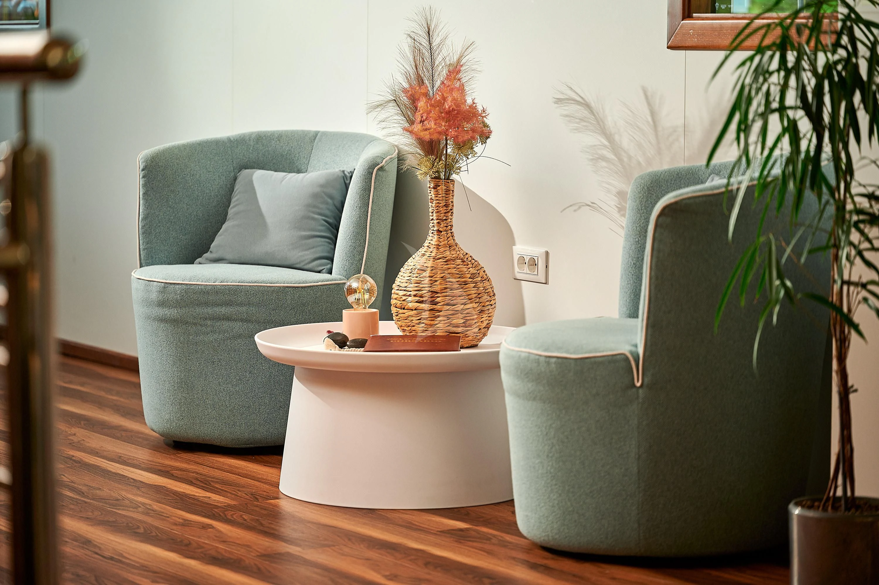 a living room with a blue couch and a vase with flowers aboard CORSARIO Yacht for Charter
