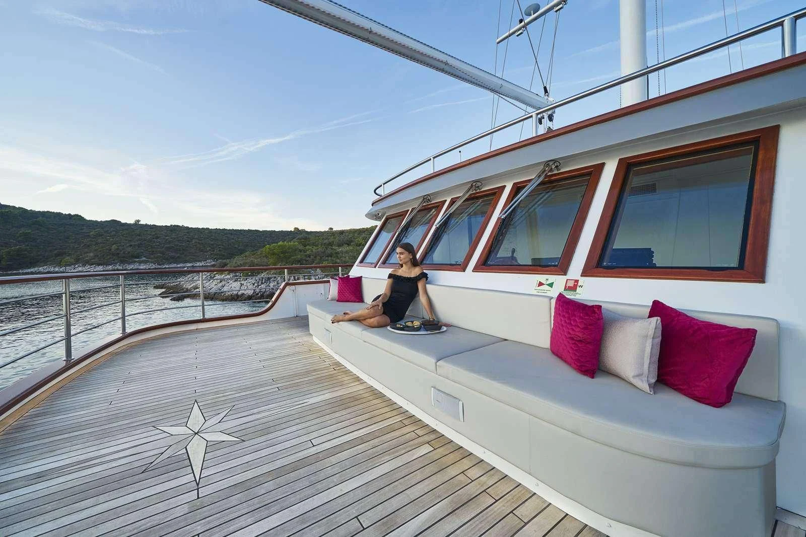 a person sitting on a boat aboard CORSARIO Yacht for Charter