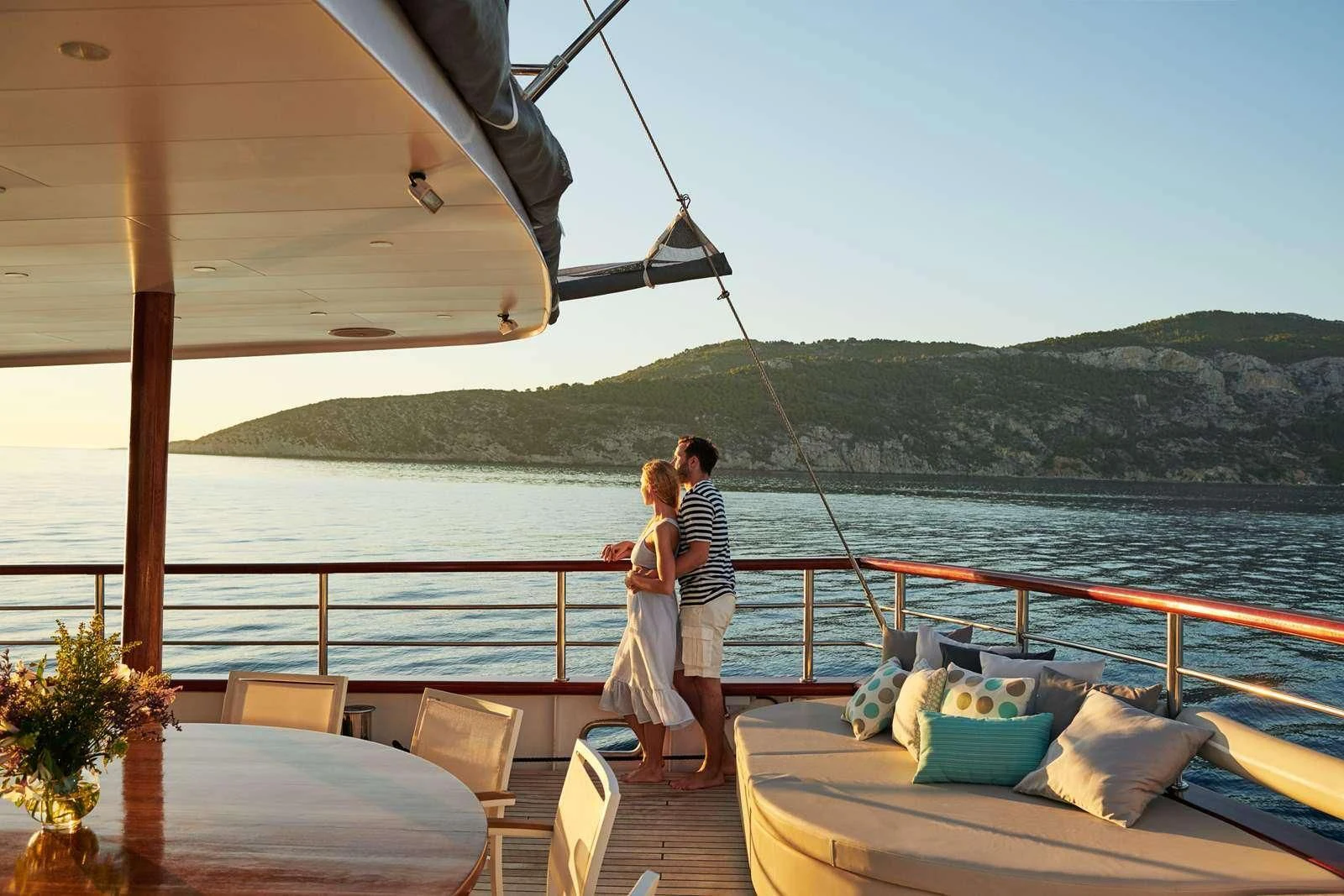 a man and woman kissing on a boat aboard CORSARIO Yacht for Charter