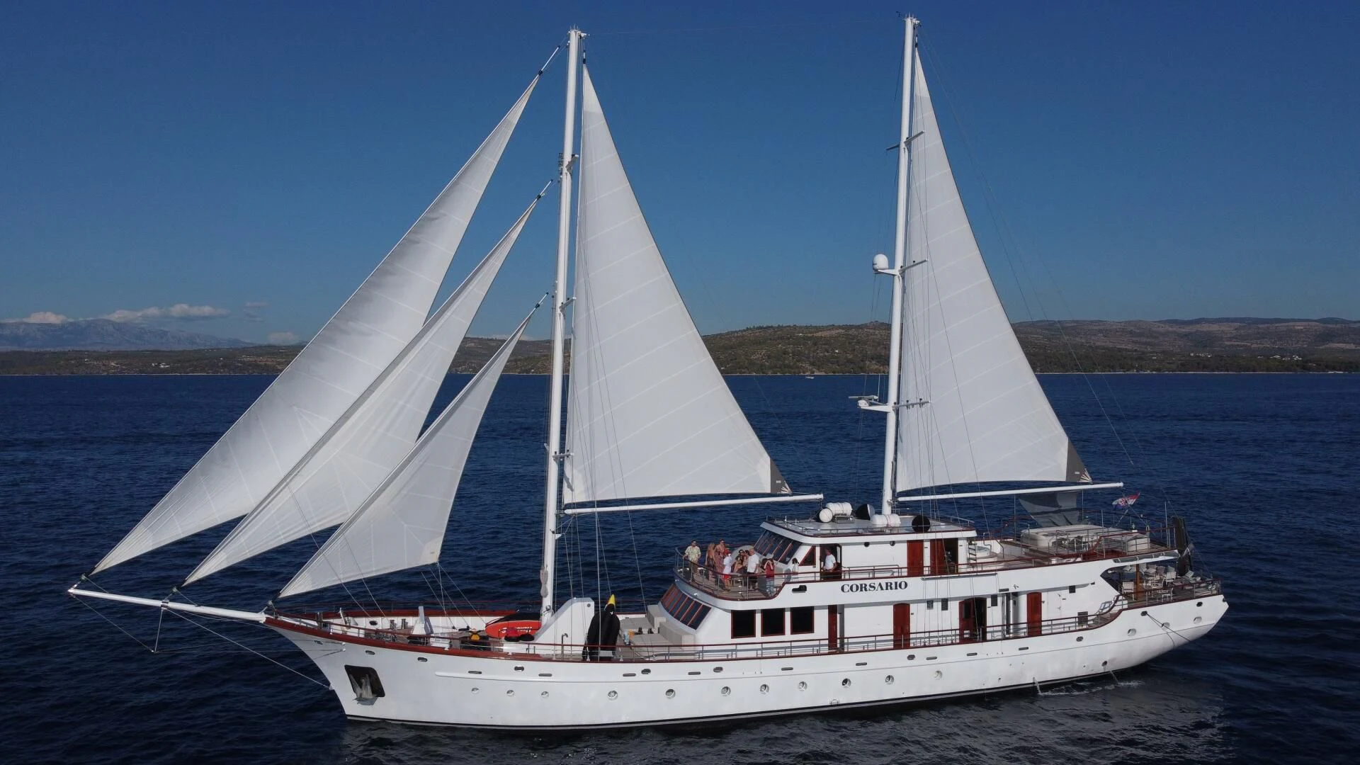 a white sailboat on the water aboard CORSARIO Yacht for Charter