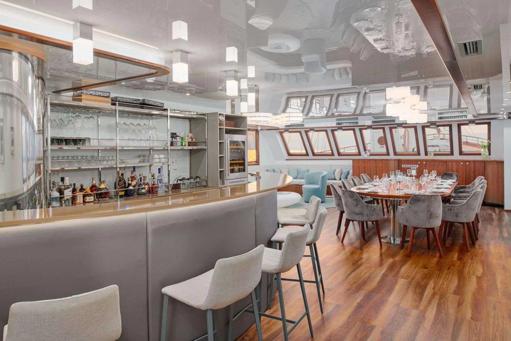 a restaurant with tables and chairs aboard CORSARIO Yacht for Charter