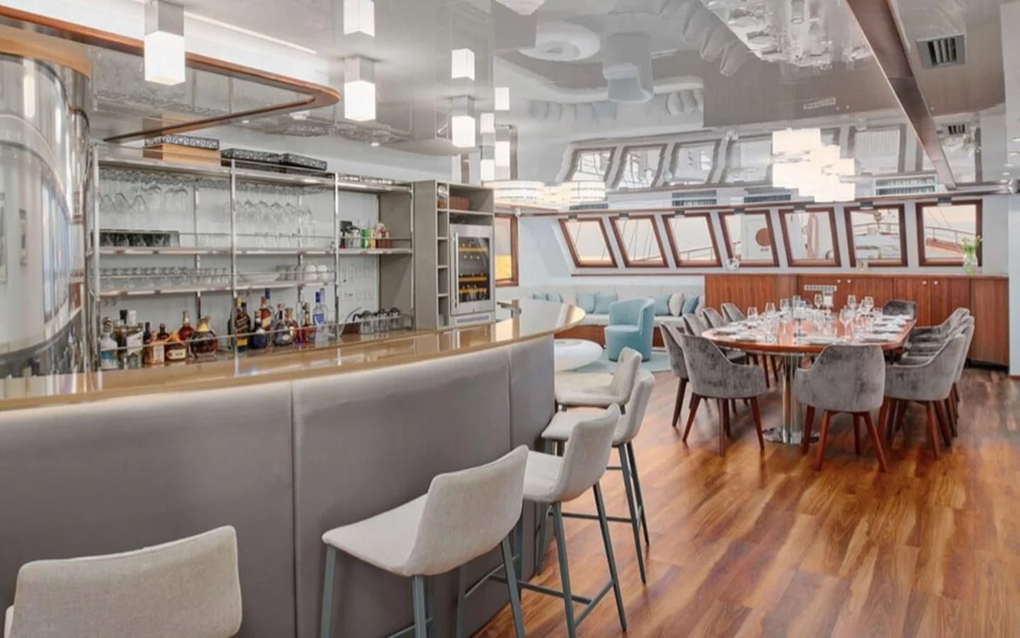 a room with tables and chairs aboard CORSARIO Yacht for Charter