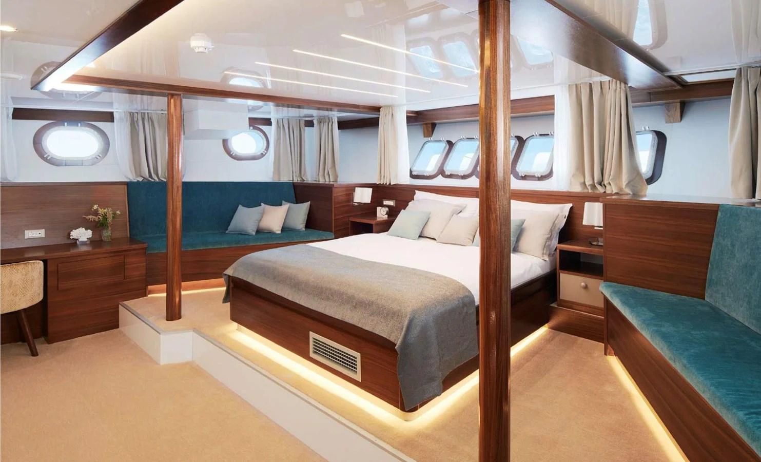 a room with a bed and a desk aboard CORSARIO Yacht for Charter