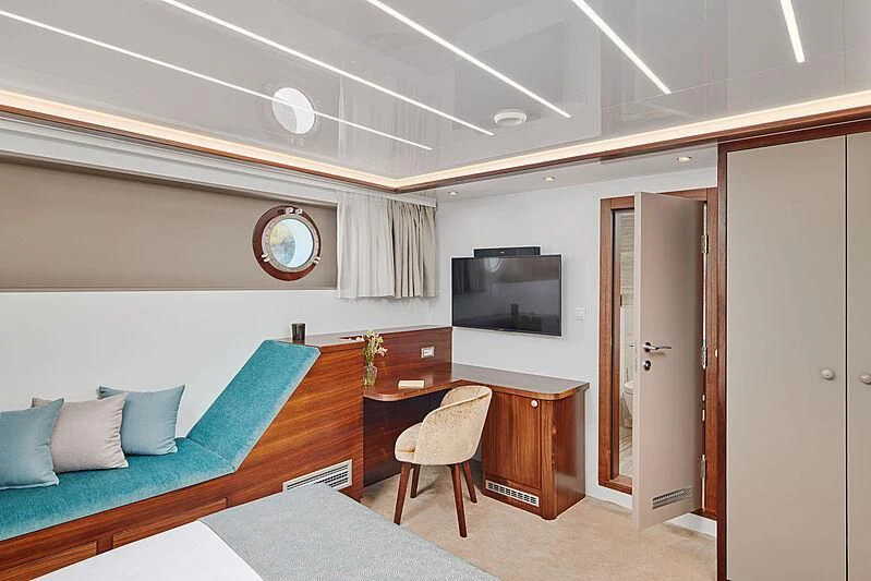 a room with a bed and a desk aboard CORSARIO Yacht for Charter