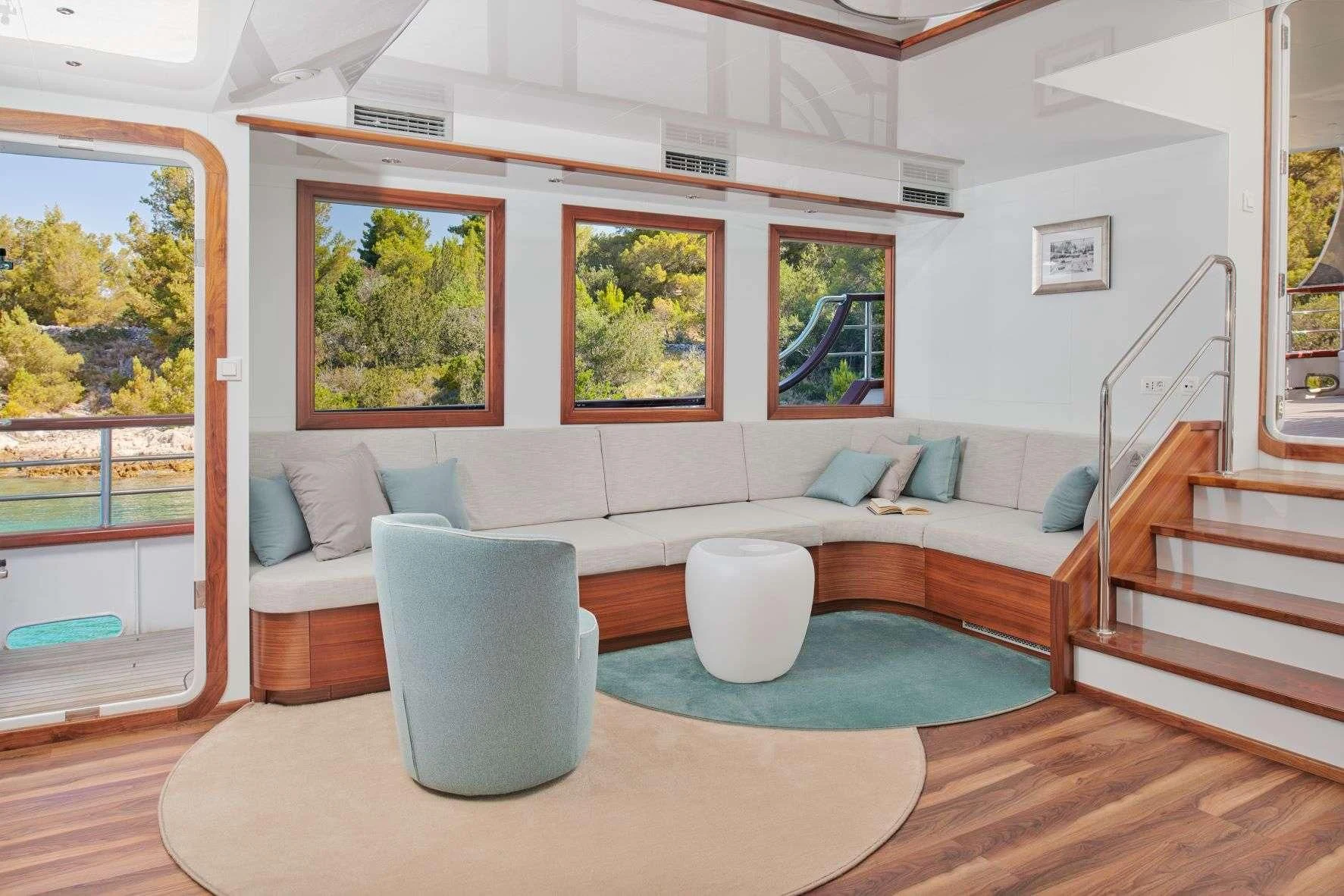 a living room with a couch and a table aboard CORSARIO Yacht for Charter