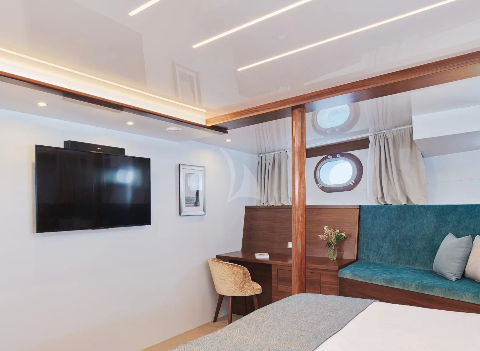 a room with a bed and a television aboard CORSARIO Yacht for Charter