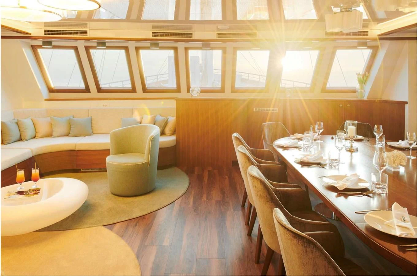 a room with a table chairs and a couch aboard CORSARIO Yacht for Charter
