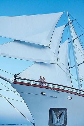 a couple of people on a sailboat aboard CORSARIO Yacht for Charter