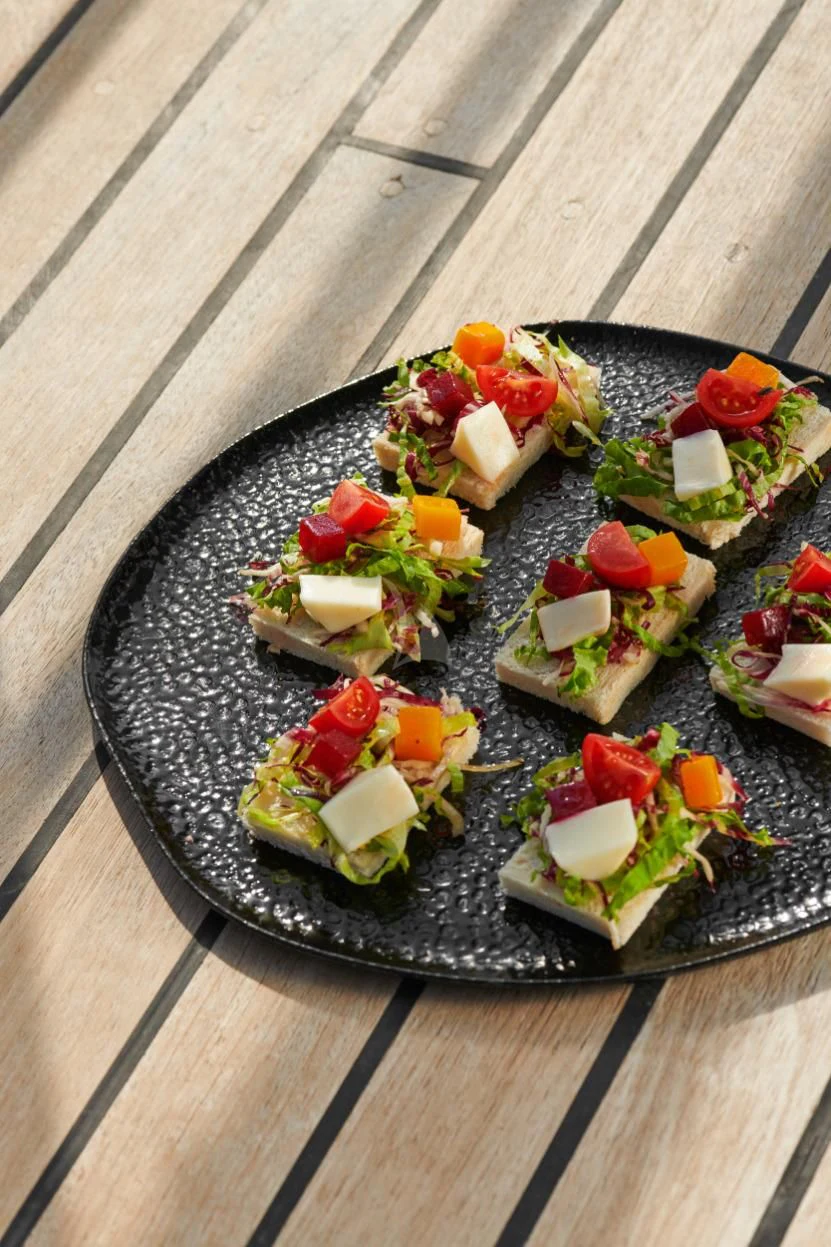 a plate of sushi on a wood table aboard CORSARIO Yacht for Charter
